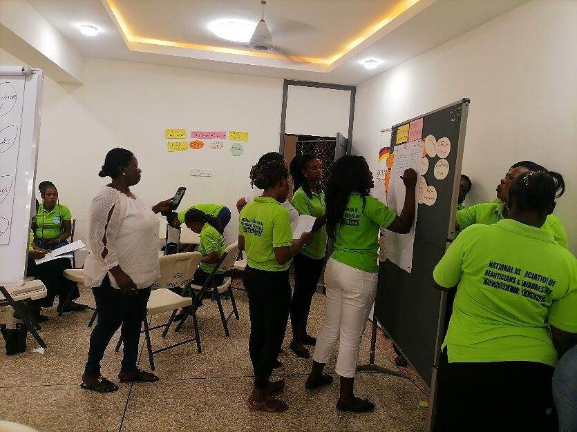 Participants clustering ideas on a board during a design thinking workshop