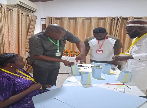 Participants building a paper prototype together at a workshop table