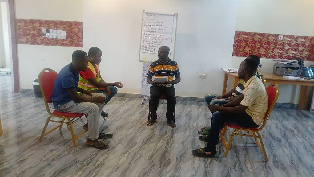 Panel of stakeholders in an open discussion at the front of a workshop room